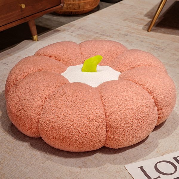 Pumpkin Plushie Pillow: A single pink Pumpkin Plushie Pillow on a table