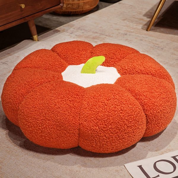 Pumpkin Plushie Pillow: A single orange Pumpkin Plushie Pillow on a table